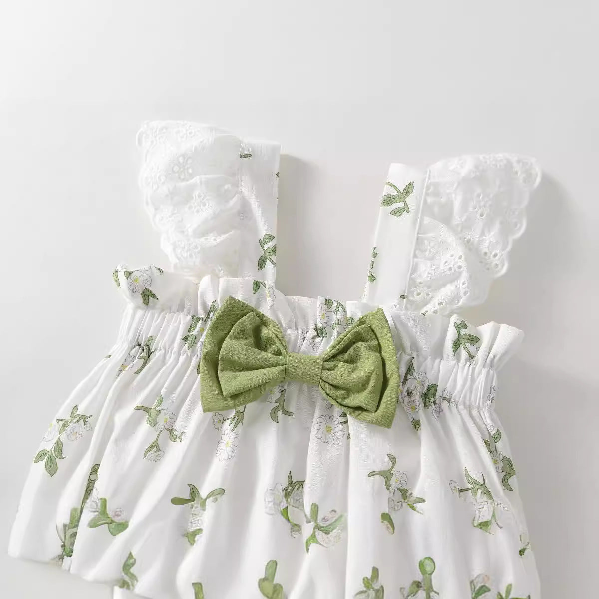 White Botanical Eyelet Romper – Flutter Lace Sleeve & Sage Bow Bodysuit (0–18M)